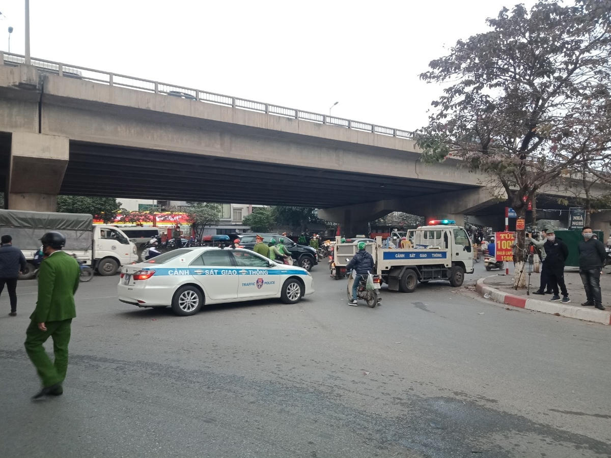 Lực lượng Công an dùng xe để ngăn không cho người dân qua khu vực cháy.