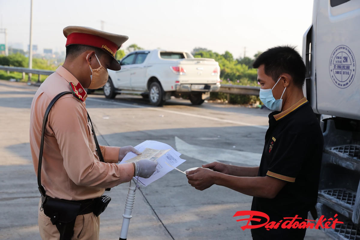 Cảnh sát giao thông yêu cầu lái xe xuất trình giấy tờ. Ảnh: Quang Vinh. 