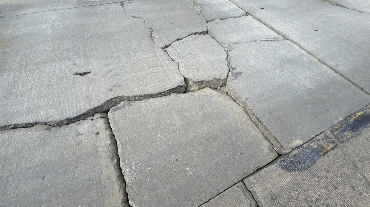 Nhiều vết nứt xuất hiện trên bề mặt đường quốc lộ 14, đoạ qua đèo Lò Xo. Ảnh: Nguyễn Tín.