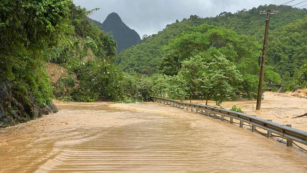 QL217, đoạn đầu cầu Phả Lò, khu phố 5, xã Quan Sơn đang bị sạt lở, nước sông Lò tràn qua mặt đường. Ảnh: Công an Quan Sơn.