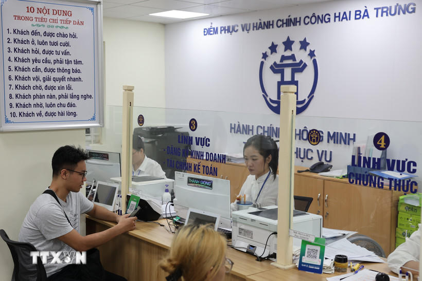 Người dân được cán bộ, công chức hỗ trợ giải quyết hồ sơ tại Điểm phục vụ Hành chính công phường Hai Bà Trưng (Hà Nội). (Ảnh: Vũ Quang/TTXVN).