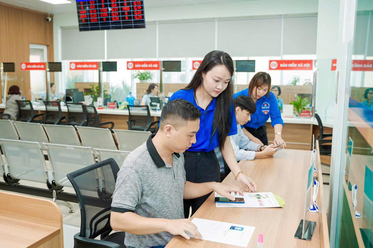 Thanh niên phường Hạ Long hỗ trợ, hướng dẫn người dân sử dụng dịch vụ công trực tuyến. Ảnh: Lê Khánh.