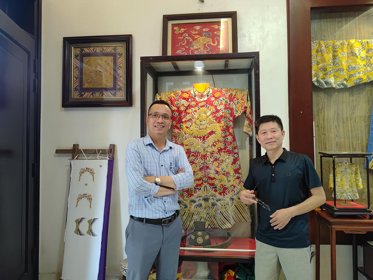 Nghệ nhân nhân dân Vũ Văn Giỏi (bên phải) cùng tác phẩm của mình.