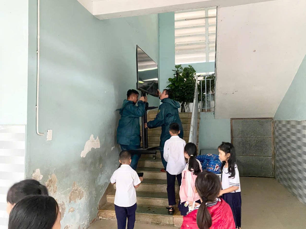 Dân quân đưa tài sản nhà trường lên cao. Ảnh: Nguyễn Đức Cường.