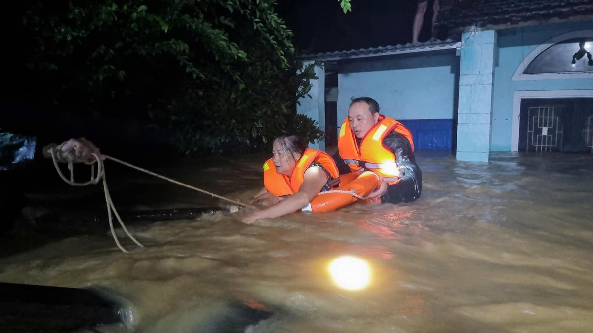Lực lượng chức năng xã Đại Lộc, TP Đà Nẵng đang giải cứu bà Trần Thị Bốn trong ngôi nhà ngập nước sâu. Ảnh: CV.