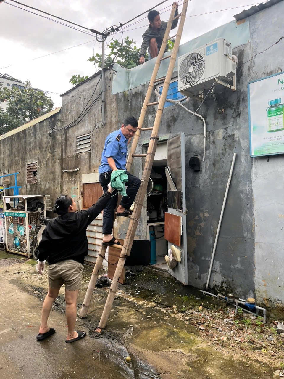 Các tổ quản lý chợ chằng chống mái tôn khu vực chợ.&nbsp;Ảnh: Nguyễn Tú.