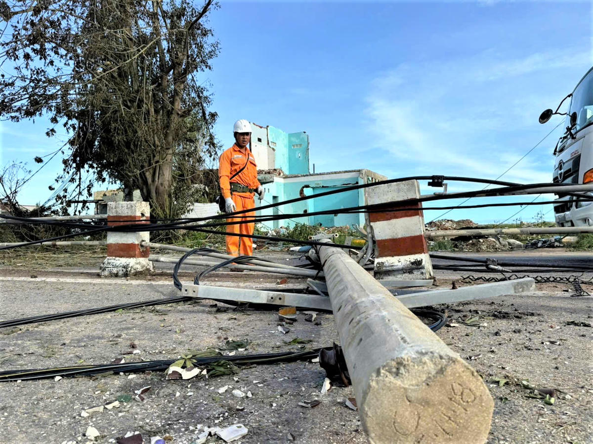 Trụ điện ngã đổ ra đường ở phường Quy Nhơn. Ảnh: Đình Sang.