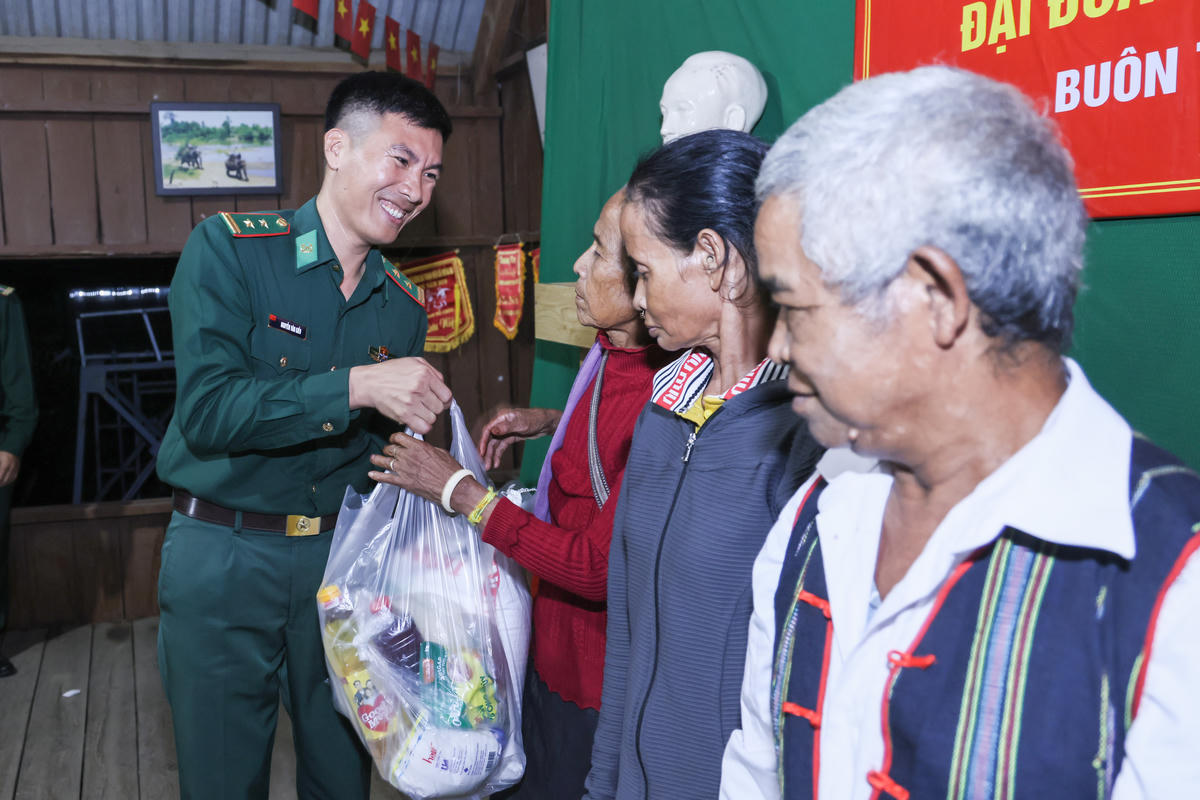 Lãnh đạo Đồn Biên phòng Sê Rê pốk tặng quà cho các hộ nghèo. Ảnh: Quang Vinh.