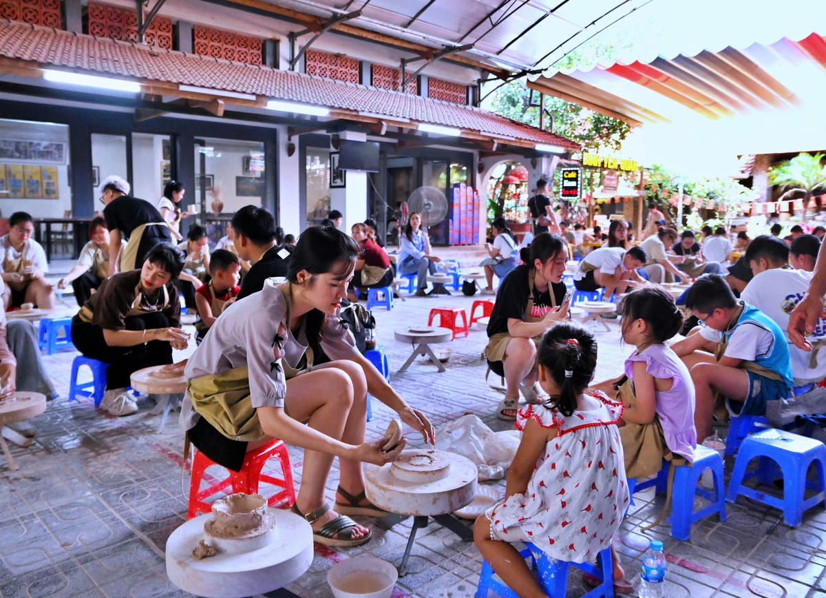  Du khách trải nghiệm làm gốm thủ công tại làng gốm Bát Tràng (Hà Nội). 	Ảnh: P. Sỹ.