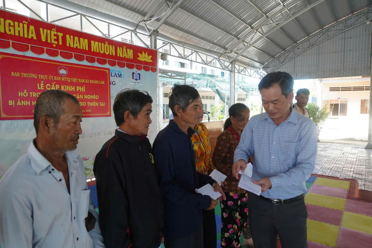 Phó Chủ tịch Ủy ban MTTQ Việt Nam tỉnh Cà Mau Nguyễn Văn Khởi trao kinh phí hỗ trợ những hộ nghèo, cận nghèo bị ảnh hưởng do thiên tai ở xã Khánh lâm. Ảnh: Nguyên Du