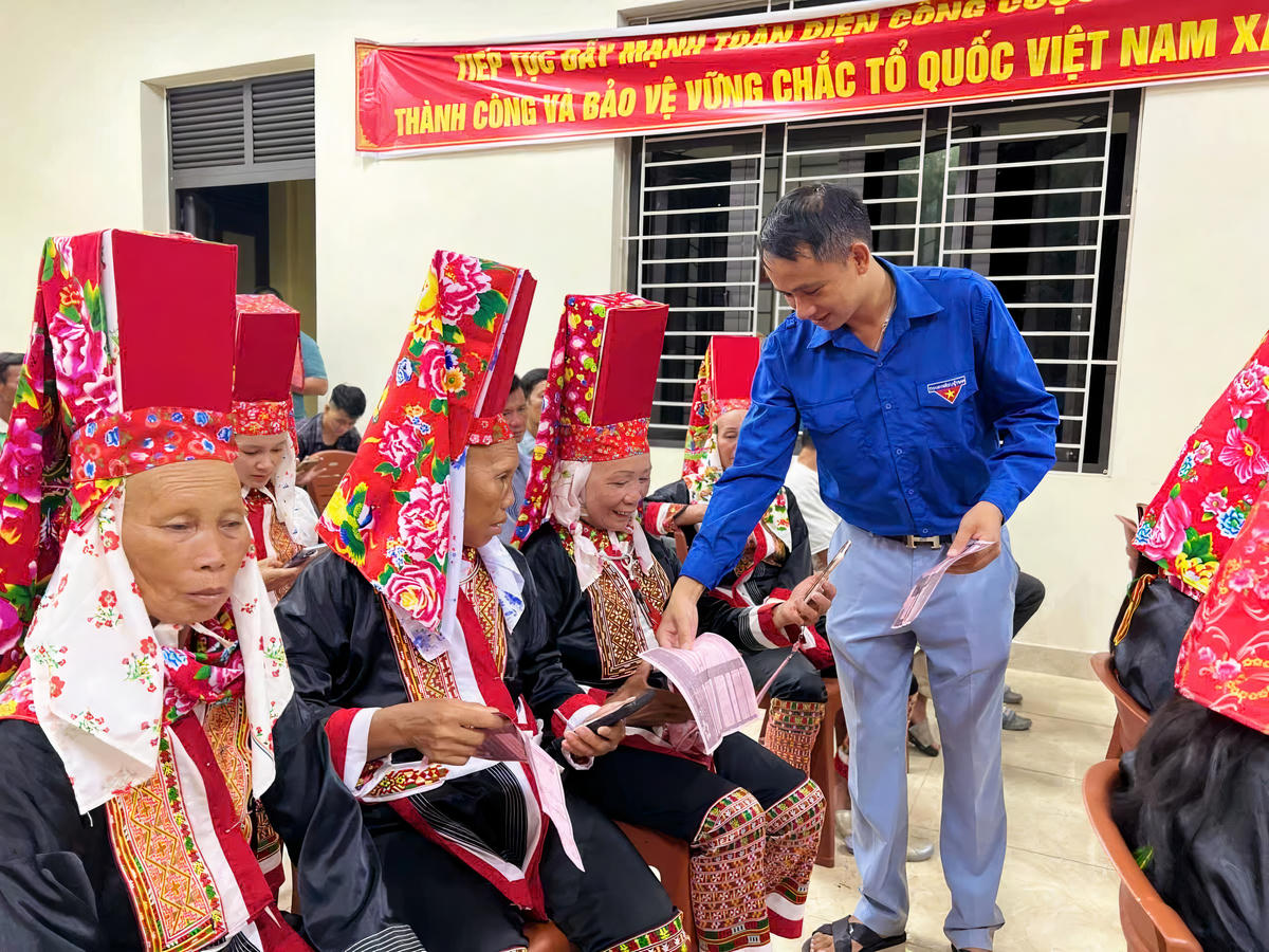 Bà con đồng bào DTTS được hướng dẫn sử dụng điện thoại thông minh để cập nhật thông tin giảm nghèo và tìm hiểu những thông hữu ích cho sản xuất. Ảnh: Nguyễn Quý