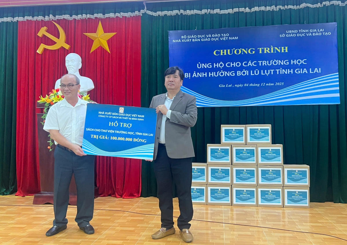 Ông Nguyễn Quốc Huy - Giám đốc công ty CP Sách và Thiết bị Bình Định (trái) trao biển tặng cho lãnh đạo Sở