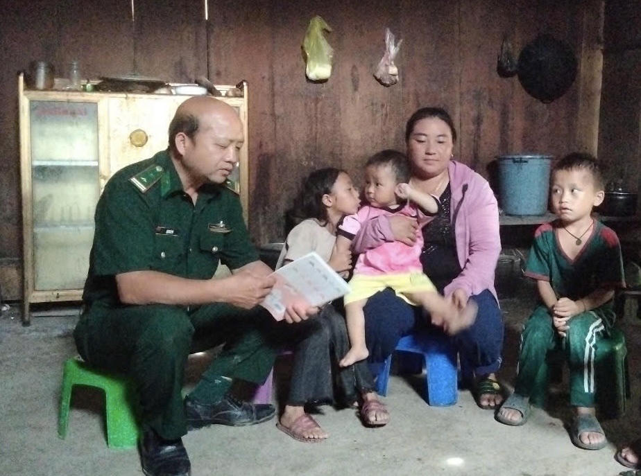 Bộ đội biên phòng tới vận động người dân đi học xóa mù chữ.