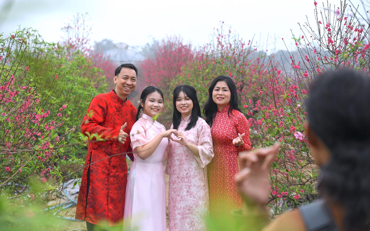 
Không chỉ thương lái, nhiều gia đình, bạn trẻ cũng tìm đến đây chụp ảnh, lưu giữ khoảnh khắc xuân. Ảnh: Phạm Sỹ.