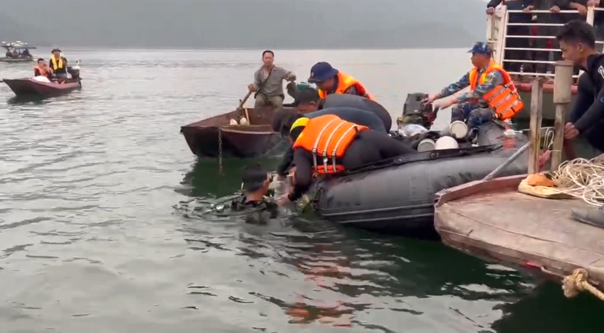 Lực lượng chức năng trục vớt thi thể nạn nhân cuối cùng của vụ chìm tàu chở khách lên bờ. Ảnh: T.Đ.