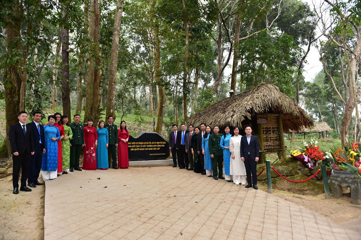 Các đại biểu chụp ảnh lưu niệm tại Lán Nà Nưa, Tân Trào. Ảnh: Xuân Trường.