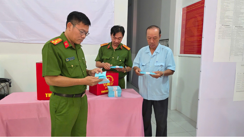 Thượng tá Lê Minh Chánh – Trưởng Công an phường Rạch Giá (bìa trái) kiểm tra công tác chuẩn bị bầu cử tại điểm bỏ phiếu số 27, phường Rạch Giá. (ảnh: Văn Vũ)