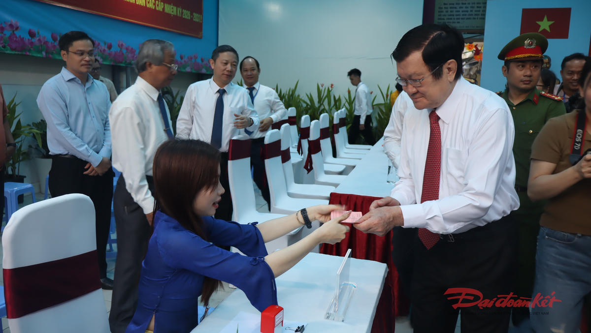 Nguyên Chủ tịch nước Trương Tấn Sang nhận đóng dấu xác nhận đã hoàn thành bỏ phiếu bầu cử. Ảnh: Hồng Phúc.