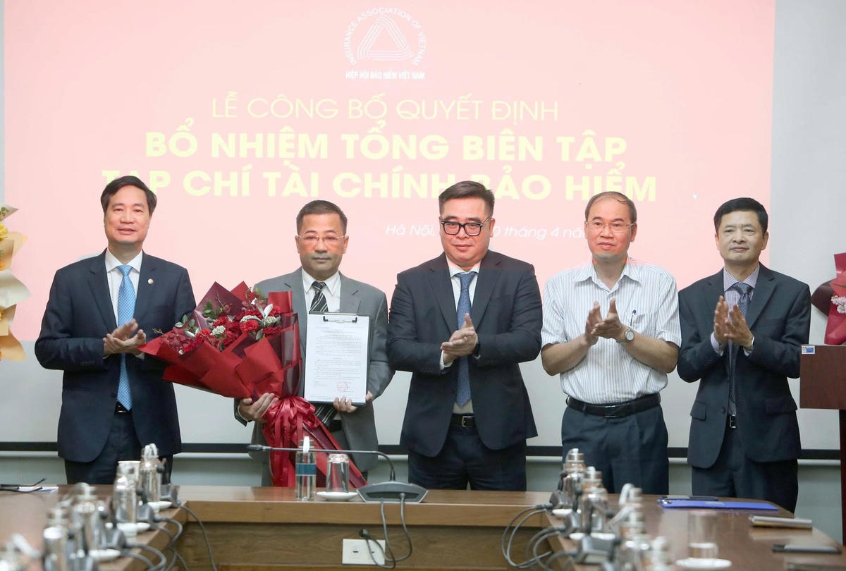 Các đại biểu tặng hoa chúc mừng nhà báo Nguyễn Phong Cầm. Ảnh: Tuấn Minh.&nbsp;