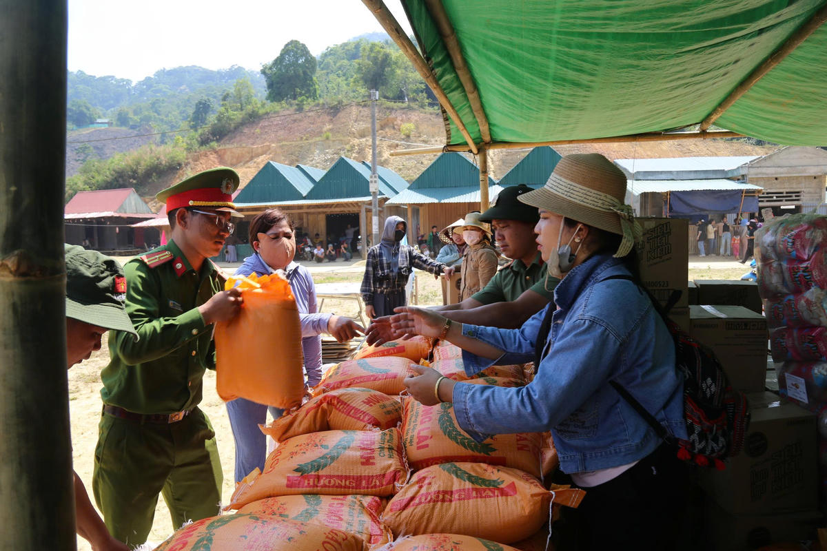 Lực lượng chức năng trao quà đến bà con người Lào trong chương trình Tết Bunpimay. Ảnh: Nguyễn Tín.