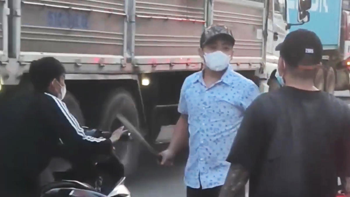 Một trong các đối tượng cầm mã tấu tấn công người khác trên đường phố. Ảnh: Cắt từ clip.