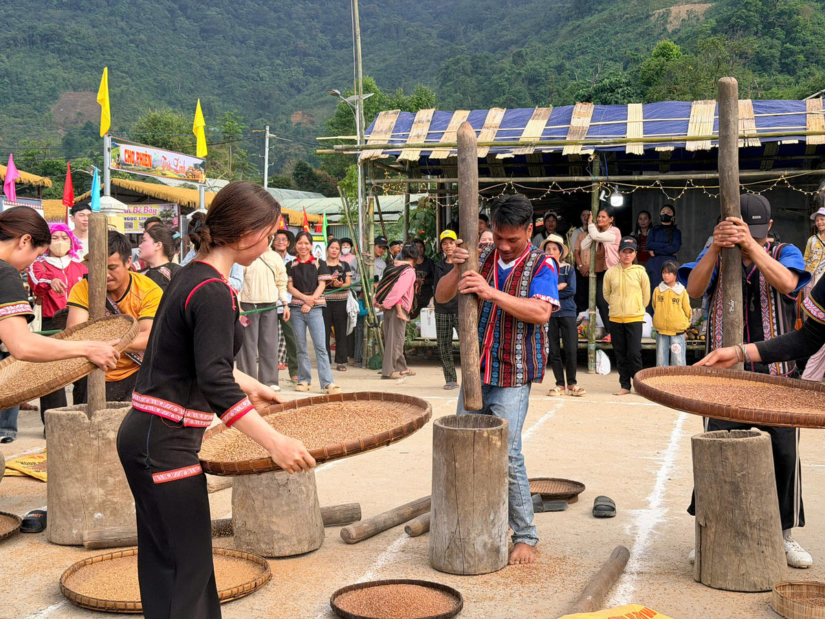 Các chàng trai, cô gái người Xơ Đăng đang thi sôi nổi phần thi giã lúa rẫy. Ảnh Tân Tân.
