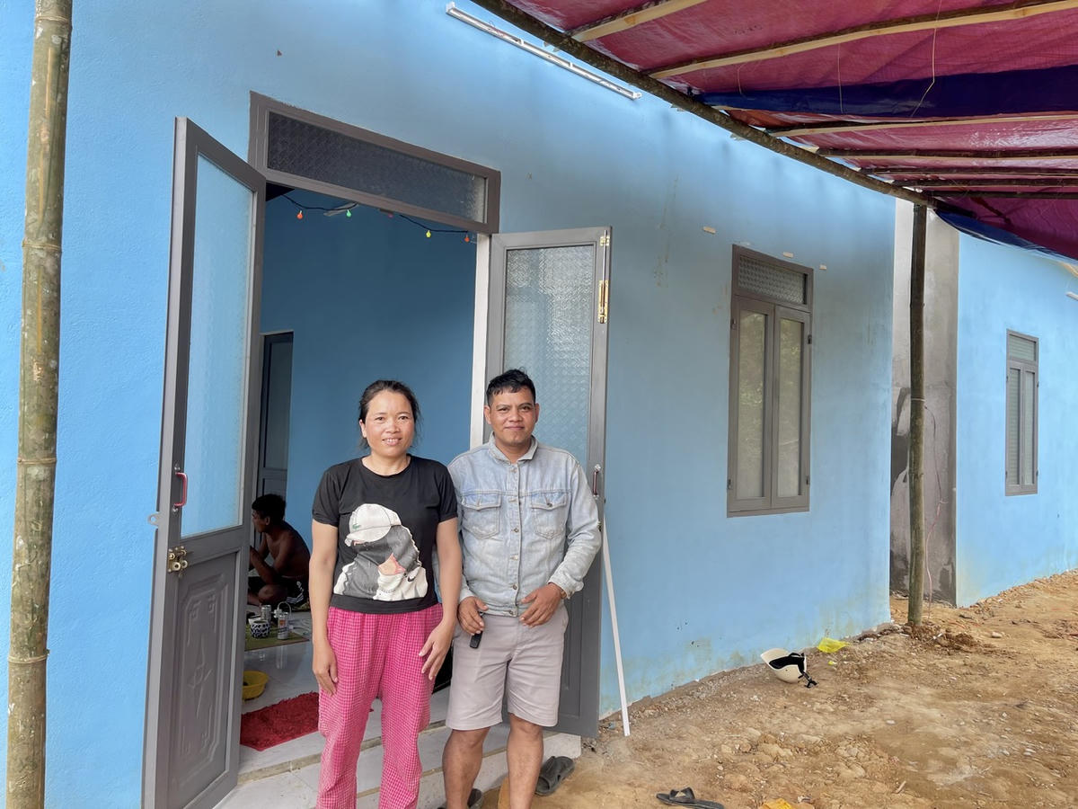 Vợ chồng chị Nguyễn Thị Nhật Mai vui mừng bên ngôi nhà mới. Ảnh: Tấn Thành.