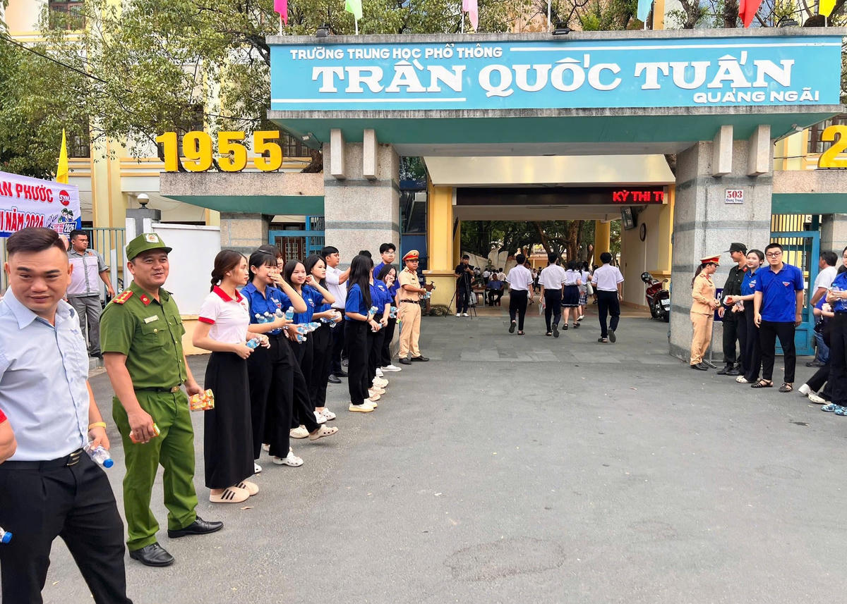 Lực lượng chức năng cùng đoàn viên thanh niên tiếp sức tại điểm thi tại Trường THPT Trần Quốc Tuấn. Ảnh: CS.
