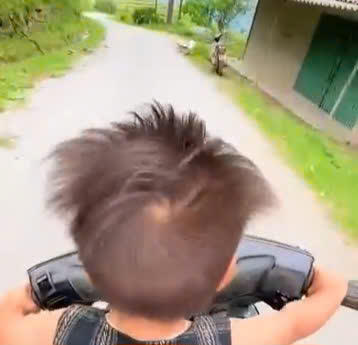 Hình ảnh cháu bé điều khiển xe xuống dốc với tốc độ cao. Ảnh: Cắt từ clip.