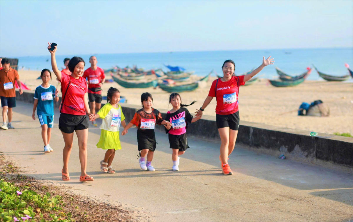 Phụ huynh cùng các em nhỏ tham gia một hoạt động chạy bộ dọc bờ biển Tam Thanh. Ảnh: CĐ.