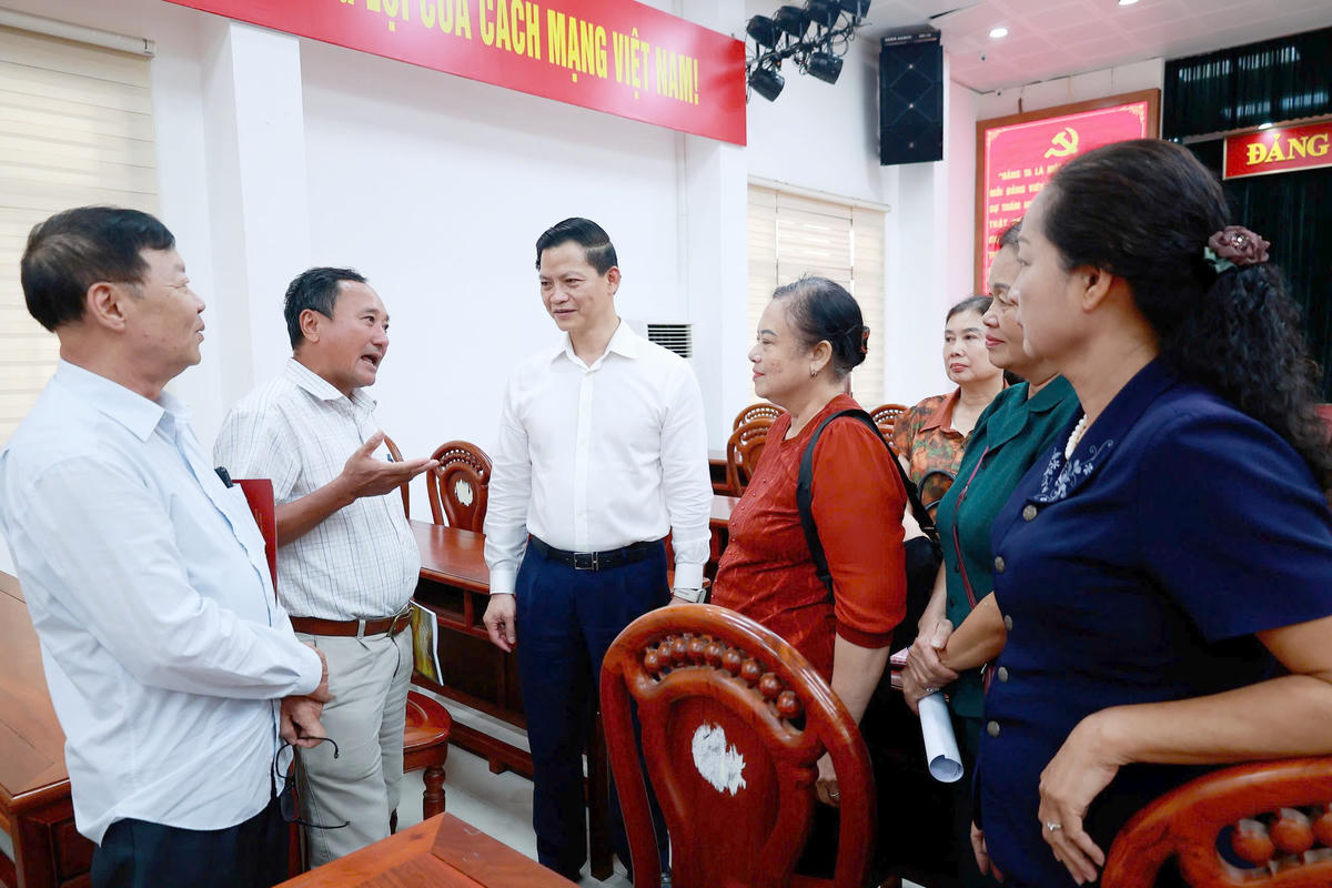 Chủ tịch UBND tỉnh Thái Nguyên Vương Quốc Tuấn (đứng giữa) trao đổi với cử tri bên lề hội nghị. Ảnh: TNGOP.