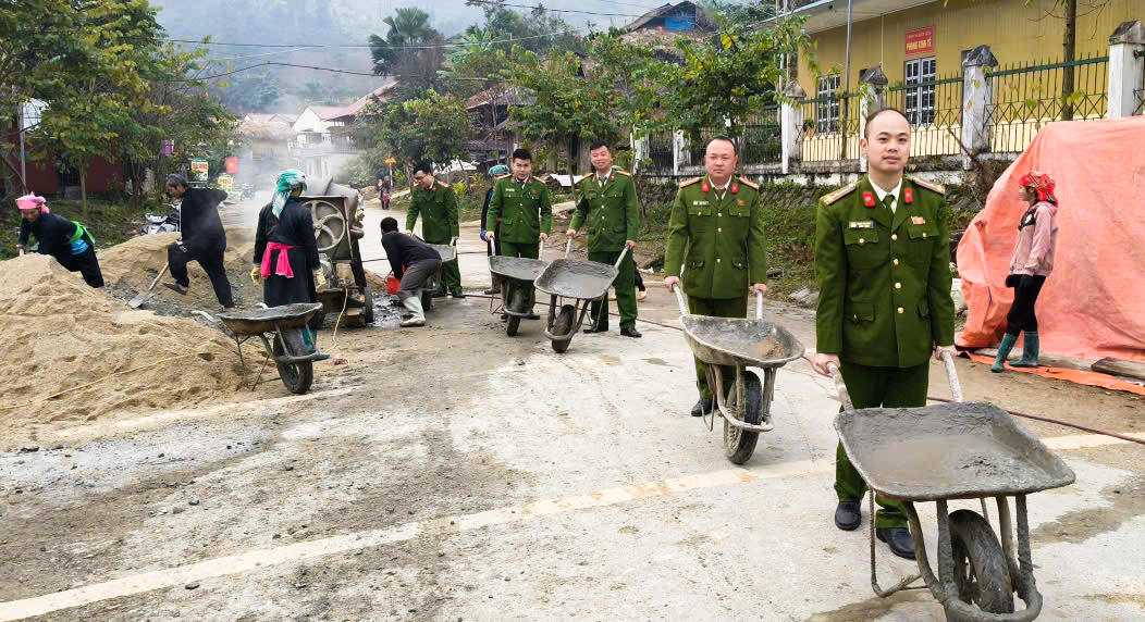 Cán bộ, chiến sĩ Công an xã Bản Liền cùng người dân sửa chữa đường sá.
