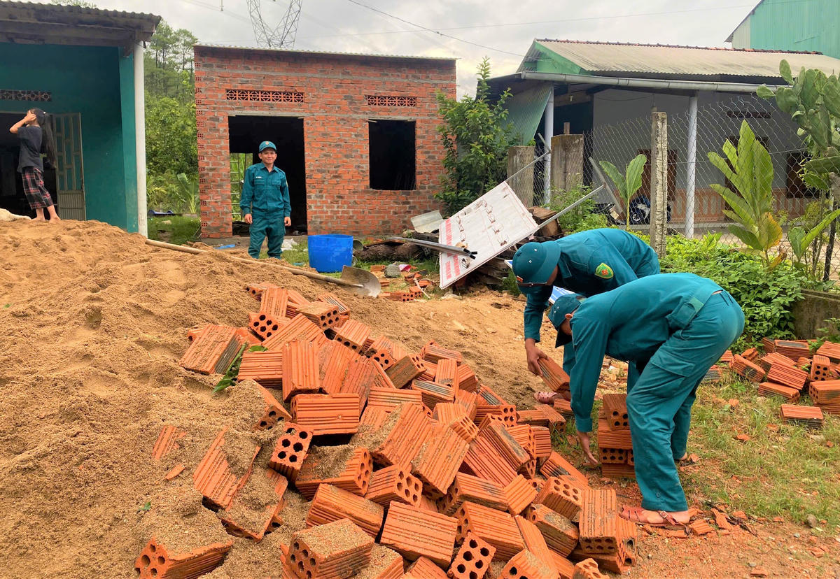 Lực lượng dân quân xã Đăk Pék hỗ trợ xây dựng nhà cho gia đình chị Y Đức xây dựng nhà ở. Ảnh: BT.
