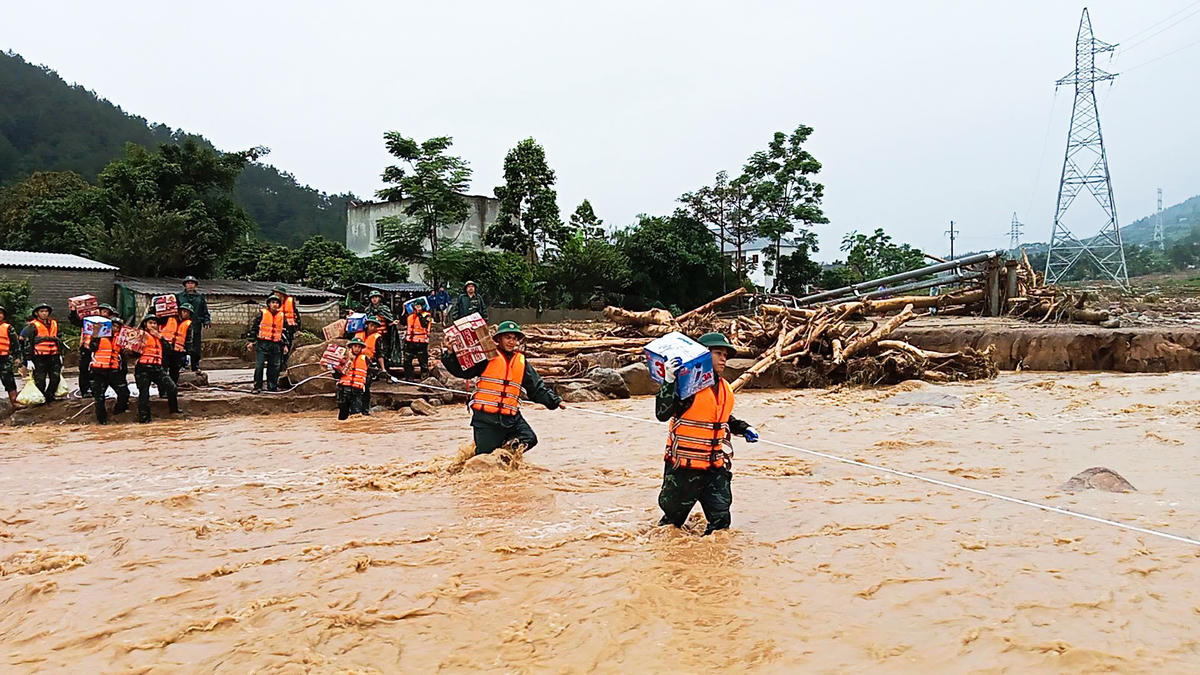 Các cán bộ, chiến sĩ thuộc lực lượng Bộ Chỉ huy Quân sự tỉnh Lai Châu vào Bản Chít đang bị cô lập do mưa lũ để tiếp tế cho người dân. Ảnh: LLVT tỉnh Lai Châu.