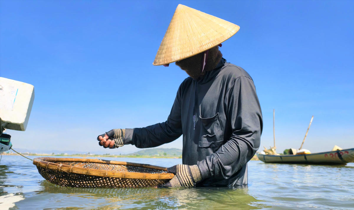 Ông Nguyễn Lực đang cào don trên sông Trà Khúc. Ảnh: DL.