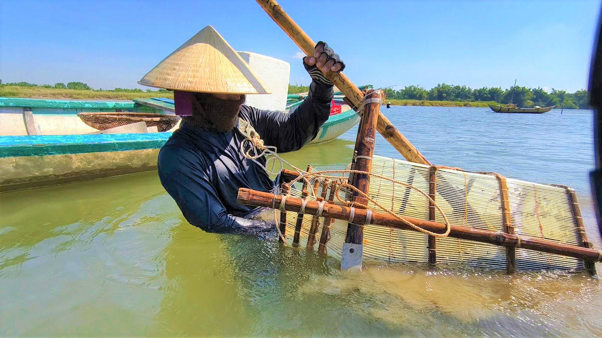 Người dân dùng dụng cào don dưới lòng sông Trà Khúc. Ảnh: DL.