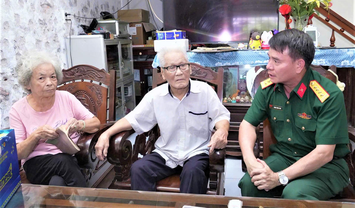 Đại tá Trịnh Công Sơn, Phó Chính ủy Bộ Chỉ huy Quân sự tỉnh Quảng Ngãi (bên trái) trao đổi với ông Thạnh và bà Ngân về những thông tin liên quan đến Bệnh xá Quân y B23. Ảnh: CH.