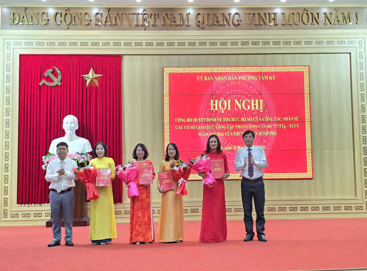 Lãnh đạo phường Tam Kỳ trao quyết định và tặng hoa cho cô Huỳnh Thị Ánh Nguyệt, (bên phải, thứ 2), Hiệu trưởng Trường THCS Tam Kỳ. Ảnh: CĐ.
