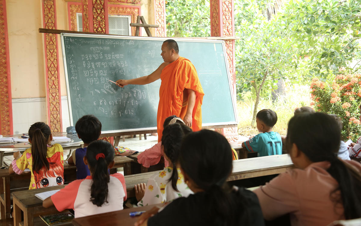 Đại đức Danh Dung - Trụ trì Chùa Đồng Tranh dạy chữ Khmer cho các em học sinh. Ảnh: Thanh Tiến