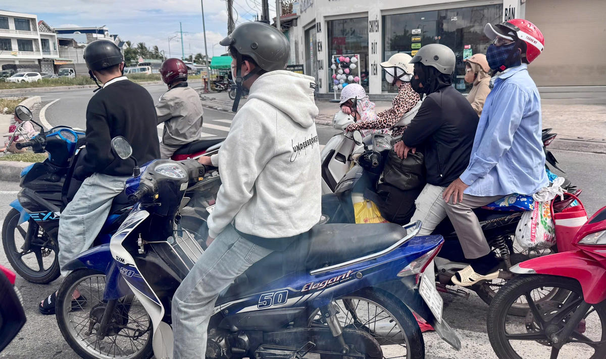 Người dân chở theo hành lý, con nhỏ dừng chờ đèn tín hiệu, bắt đầu hành trình về quê dịp nghỉ lễ Quốc khánh 2/9. (Ảnh: Thanh Lâm).