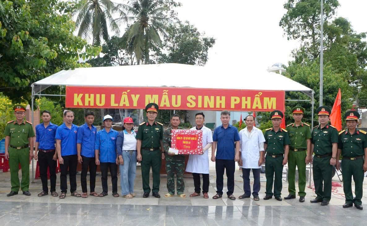Đại tá Võ Tấn Tài, Chính ủy Bộ CHQS tỉnh Gia Lai (bên trái, giữa) tặng quà cho lực lượng lấy mẫu sinh phẩm hài cốt liệt sĩ. Ảnh: QS.