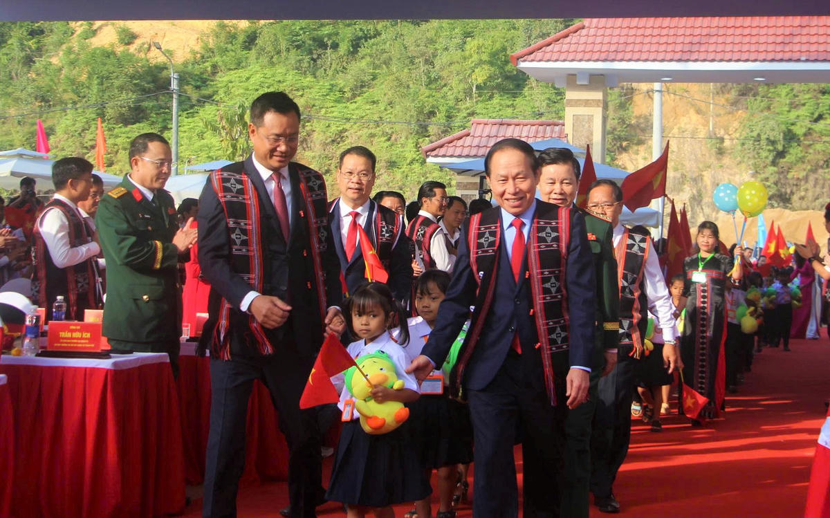 Phó Thủ tướng Chính phủ Lê Tiến Châu (bên trái) dẫn em học sinh dự lễ khai giảng tại Trường Phổ thông nội trú liên cấp Tiểu học và THCS Tây Giang. Ảnh: TT.