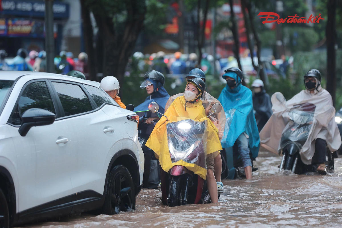 Các phương tiện lưu thông chậm vì ngập úng.