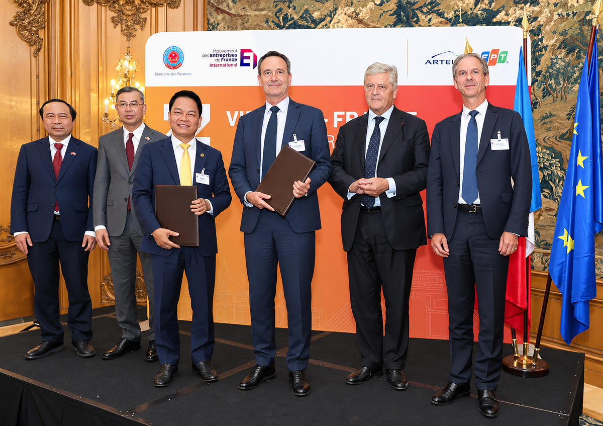 Ông Nguyễn Ngọc Nghị, Phó Tổng Giám đốc T&T Group, Chủ tịch T&T Energy Group và Ông Arnaud Lenail Chouteau, Phó Chủ tịch Cấp cao kiêm Tổng Giám đốc TotalEnergies Gas & Power Activities trao biên bản ghi nhớ về hợp tác phát triển Dự án điện khí LNG Long Sơn. Ảnh: Anh Chiến