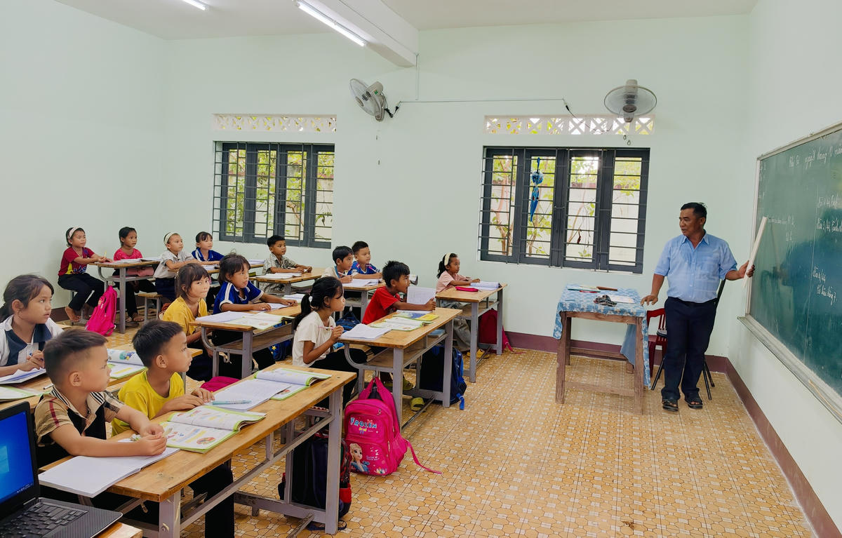 Thầy giáo Y Chội Buôn Krông đang dạy học cho các em học sinh lớp 2 và lớp 3, tại điểm trường cũ ở buôn Đrang Phốk. Ảnh: Thanh Nga.