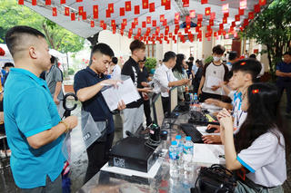 Tân sinh viên 'đội mưa' đến trường nhập học trực tiếp