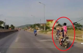 [VIDEO] Rùng mình cảnh bố để con gái đứng lên yên xe máy đi tốc độ cao