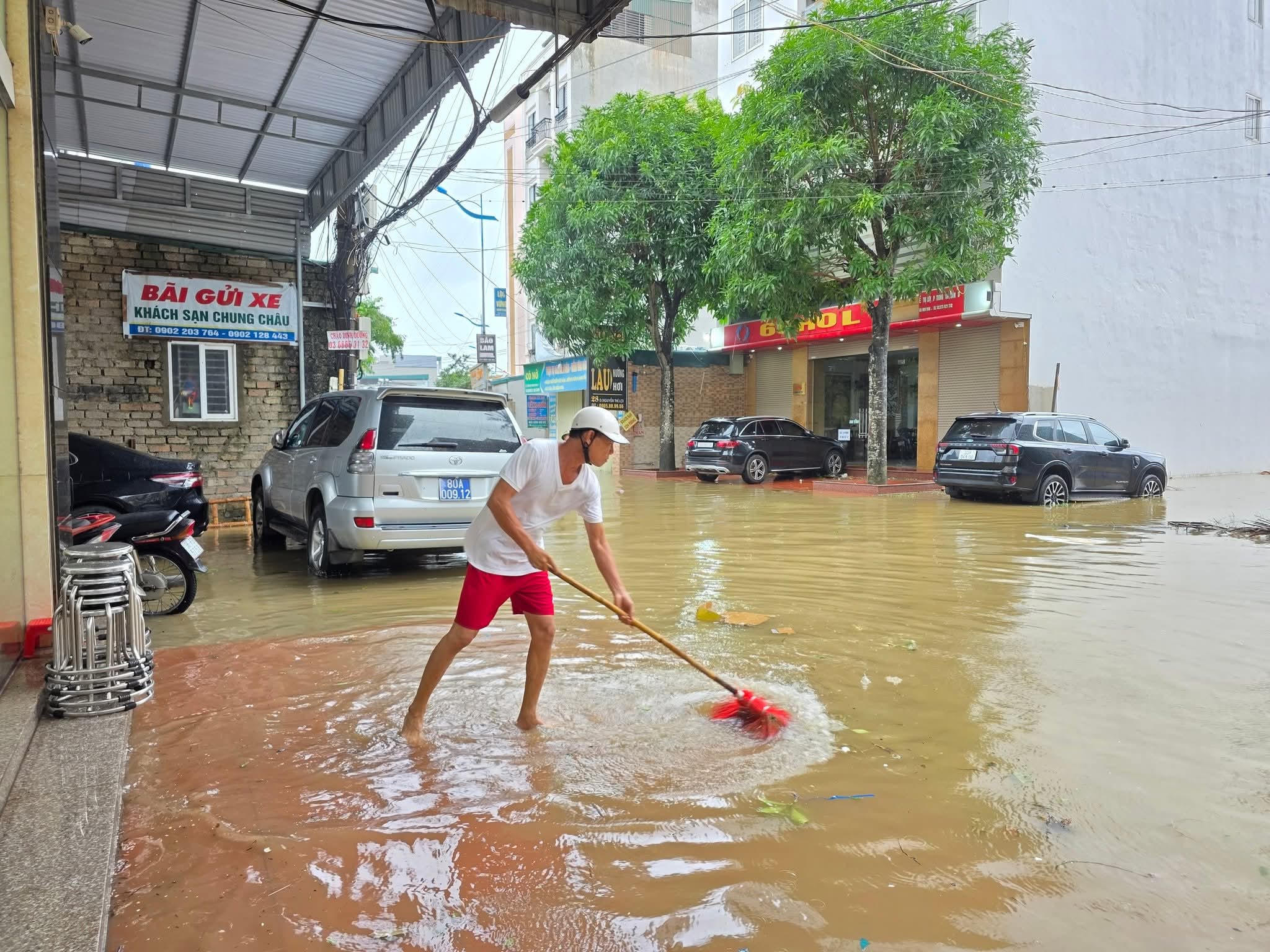  Người dân phường Sầm Sơn tranh thủ dọn dẹp nhà cửa khi nước bắt đầu xuống. Ảnh: Đỗ Anh.