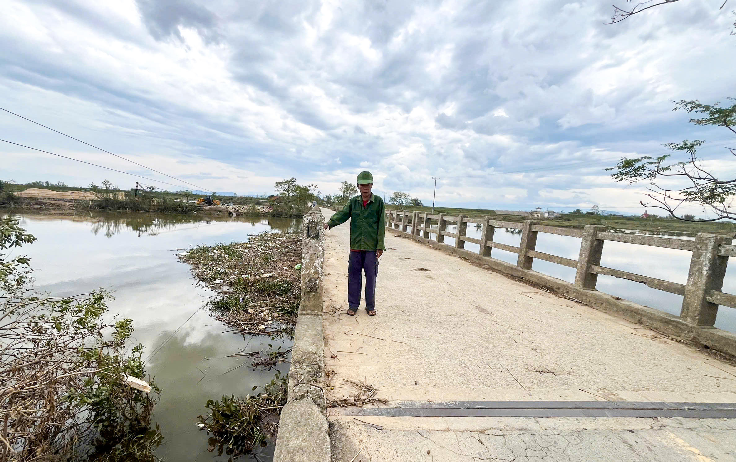 “Mấy chục năm nay cầu chưa được duy tu tổng thể lần nào. Cứ mưa lũ là rác ngập gầm cầu, người dân phải tự dọn. Giờ cầu yếu lắm rồi, chỉ mong các cơ quan chức năng sớm cho làm lại để đỡ lo”, ông Nguyễn Văn Định (trú tại thôn Vĩnh Hòa) chia sẻ. Ảnh: Cẩm Kỳ