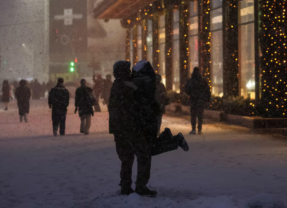 Người dân Nga đón năm mới dưới tuyết gần một trung tâm mua sắm của Moscow. Nguồn: Reuters.
